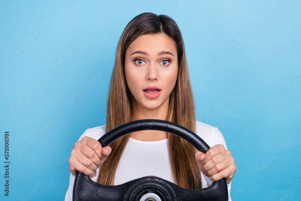Photo of impressed funny woman wear white shirt driving automobile isolated blue color background Photo of impressed funny woman wear white shirt driving automobile isolated blue color background