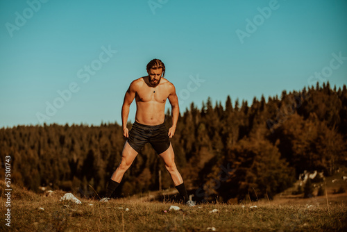 A man stretching after a hard workout in the early hours of the morning