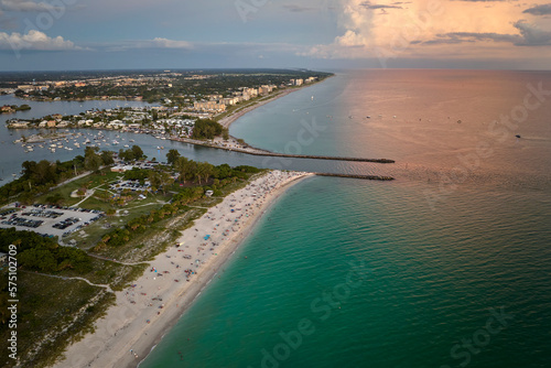 High angle view of crowded Nokomis beach in Sarasota County, USA. Many people enjoing vacations time swimming in ocean water and relaxing on warm Florida sun at sundown