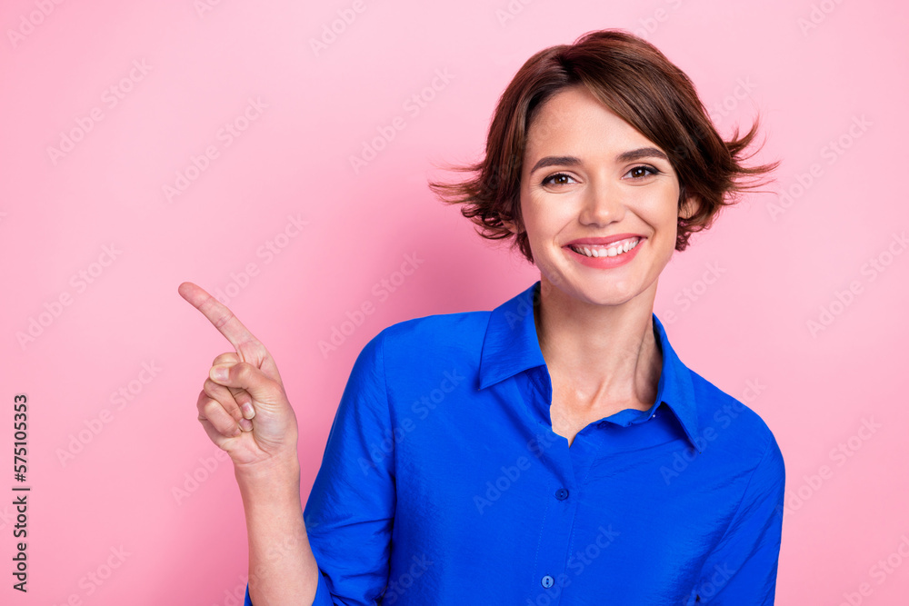 Portrait of gorgeous friendly girl beaming smile indicate finger empty space blank isolated on pink color background Portrait of gorgeous friendly girl beaming smile indicate finger empty space blank isolated on pink color background