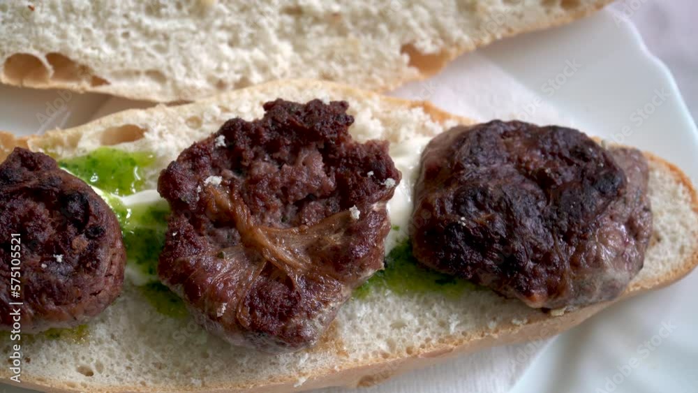 Close up, sandwich with figatells, food based on spicy meat typical of Valencia, Spain. Close up, sandwich with figatells, food based on spicy meat typical of Valencia, Spain.