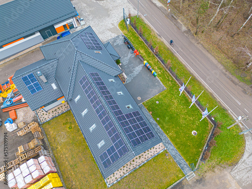 High angle shot of a private house situated in a valley with solar panels on the roof