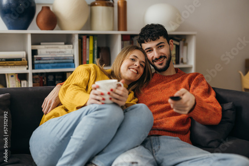 Cute young couple watches television