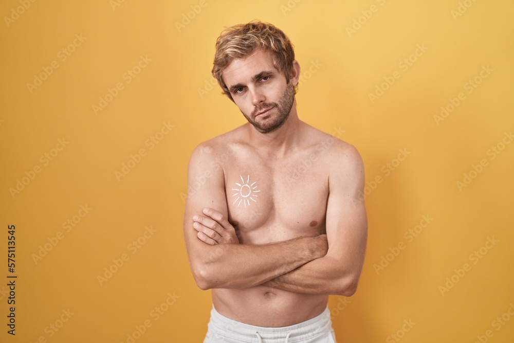 Caucasian man standing shirtless wearing sun screen looking sleepy and tired, exhausted for fatigue and hangover, lazy eyes in the morning.