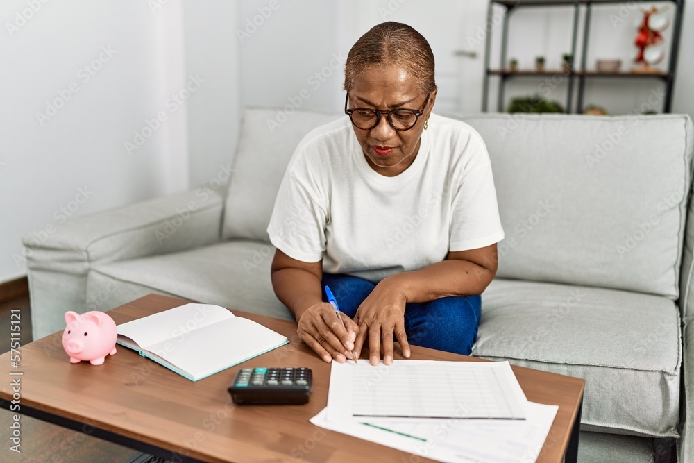 Senior african american woman controlling economy at home