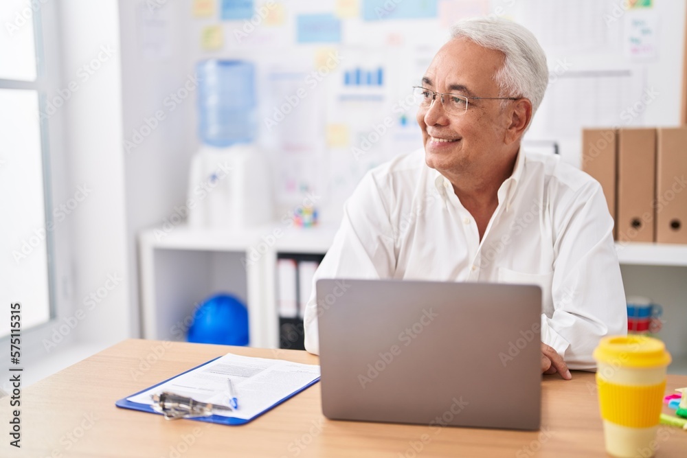 Middle age grey-haired man business worker using laptop working at office Middle age grey-haired man business worker using laptop working at office