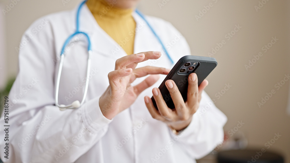 Young african american woman doctor using smartphone at clinic Young african american woman doctor using smartphone at clinic