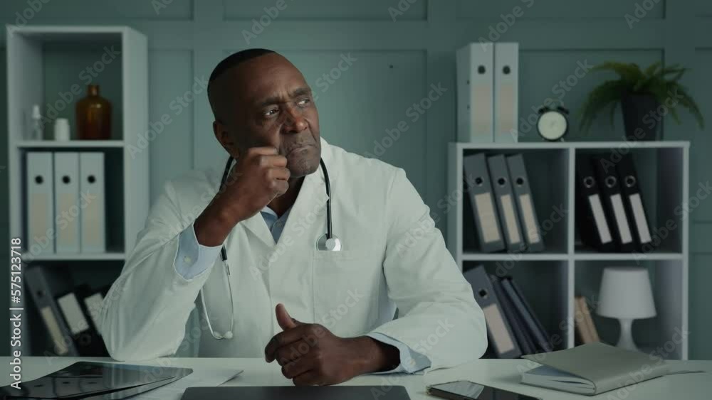 Thoughtful pensive mature adult doctor physician general practitioner african american ethnic elderly man sit at clinic office thinking brainstorming deep thought professional scientist planning idea