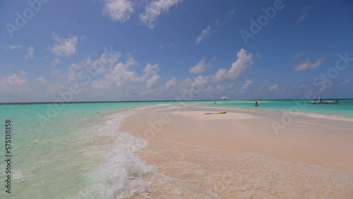 Slow Motion Beautiful View Of Sea Waves Splashing At Beach On Sunny Day Under Clouds - Thulusdhoo, Maldives photo