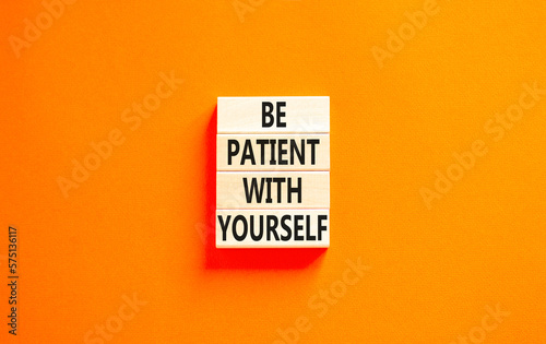 Patient with yourself symbol. Concept words Be patient with yourself on wooden blocks. Beautiful orange table orange background. Business patient with yourself concept. Copy space.