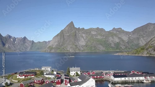 Aerial shot over a road, cars and bridge towards mountains in Lofoten, Norway