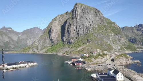 Aerial shot over a road, cars and bridge towards mountains in Lofoten, Norway