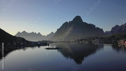 Aerial shot just above water in a fjord in Lofoten, Northern Norway in the evening