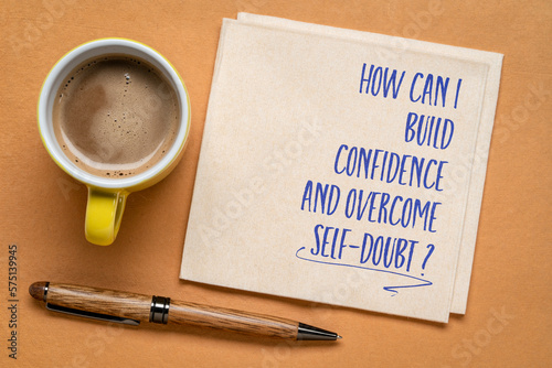 How can I build confidence and overcome self-doubt? Inspirational question on a napkin. Personal development and self help concept.