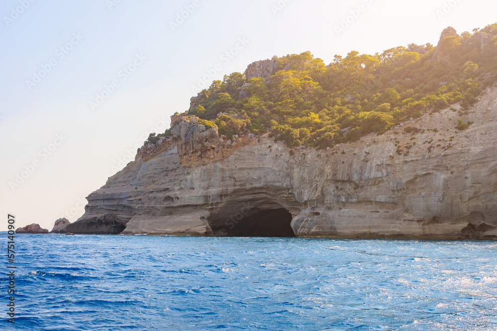View of the rocky shore from the sea. Mediterranean Sea in Turkey. Popular tourist places. Background