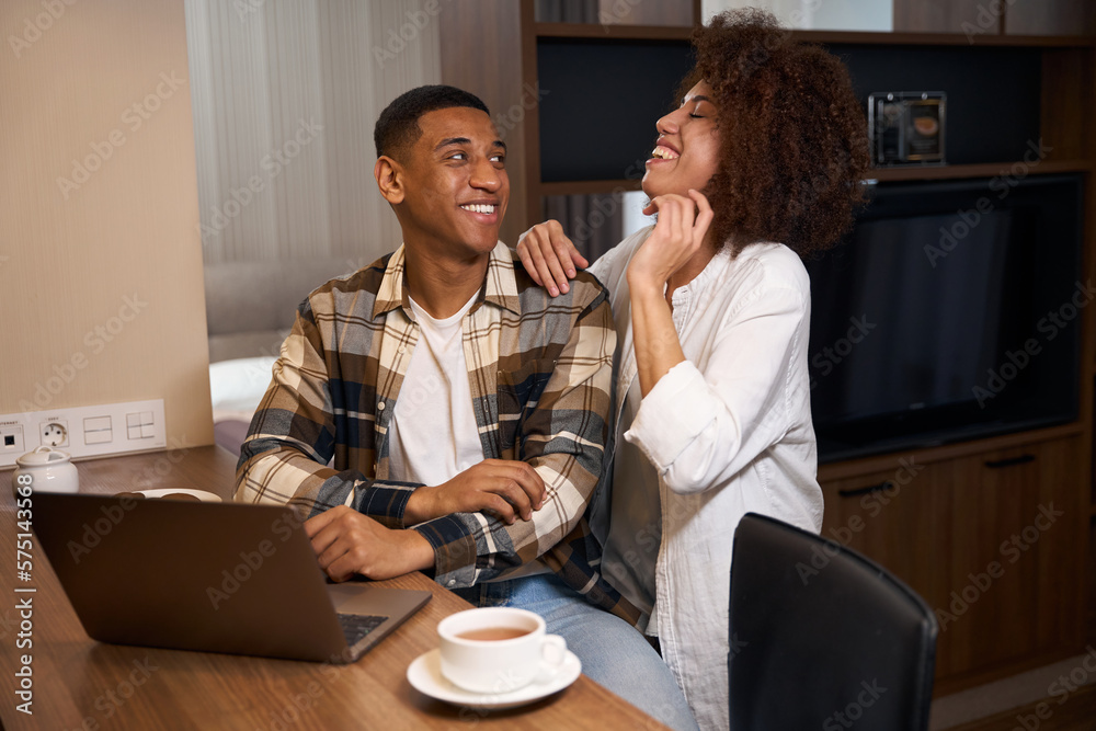 Guy and his girlfriend are having fun chatting over morning coffee Guy and his girlfriend are having fun chatting over morning coffee