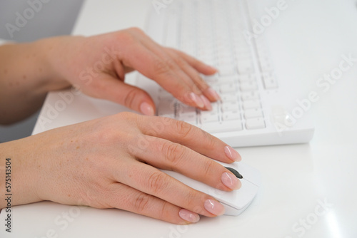 Close-up of hands woman using a mouse and keyboard computer. High quality photo