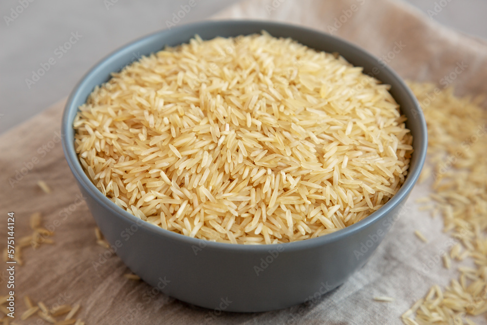 Dry Organic Indian Basmati Rice in a Bowl on a gray background, low angle view. Close-up. Dry Organic Indian Basmati Rice in a Bowl on a gray background, low angle view. Close-up.