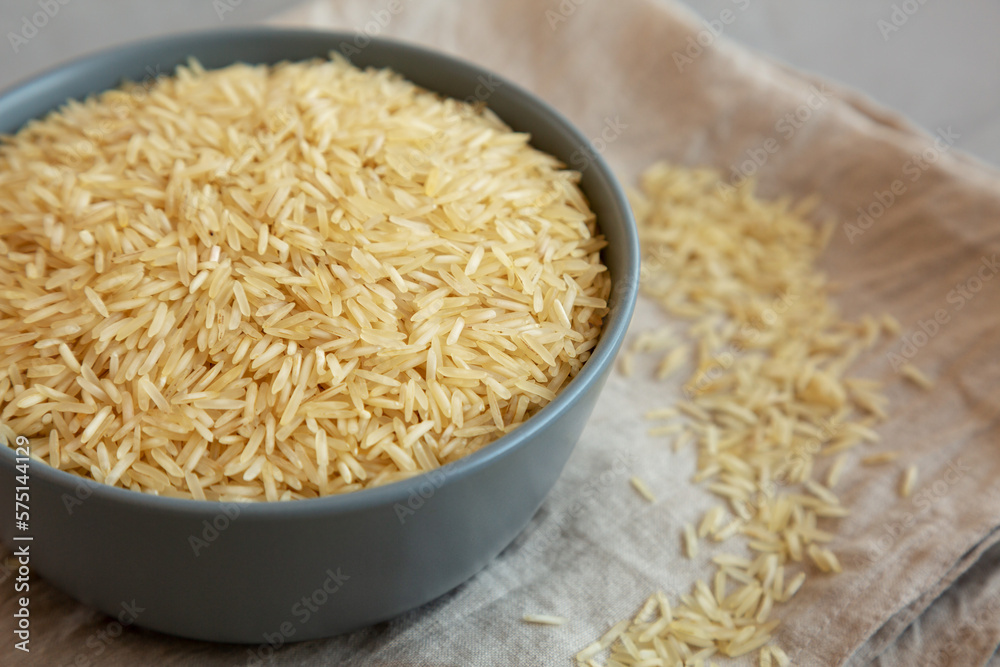 Dry Organic Indian Basmati Rice in a Bowl on a gray background, low angle view. Close-up. Dry Organic Indian Basmati Rice in a Bowl on a gray background, low angle view. Close-up.