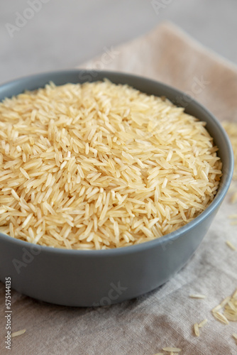 Dry Organic Indian Basmati Rice in a Bowl on a gray background, low angle view. Close-up.