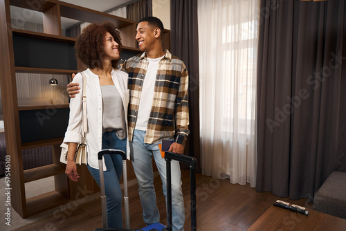 Photo of multiracial young spouses in a hotel room