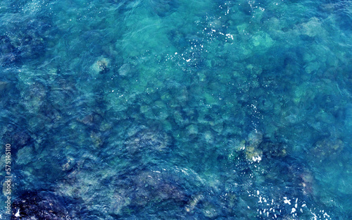 Aerial view of the ocean water surface and waves. Beautiful water background texture for tourism and advertising. Tropical coast