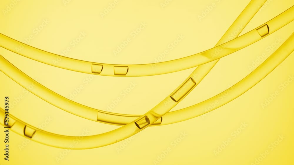 Macro shot of yellow transparent fluid is flowing in three transparent lab connecting tubes on yellow background | Abstract face care serum with vitamin C formulating concept