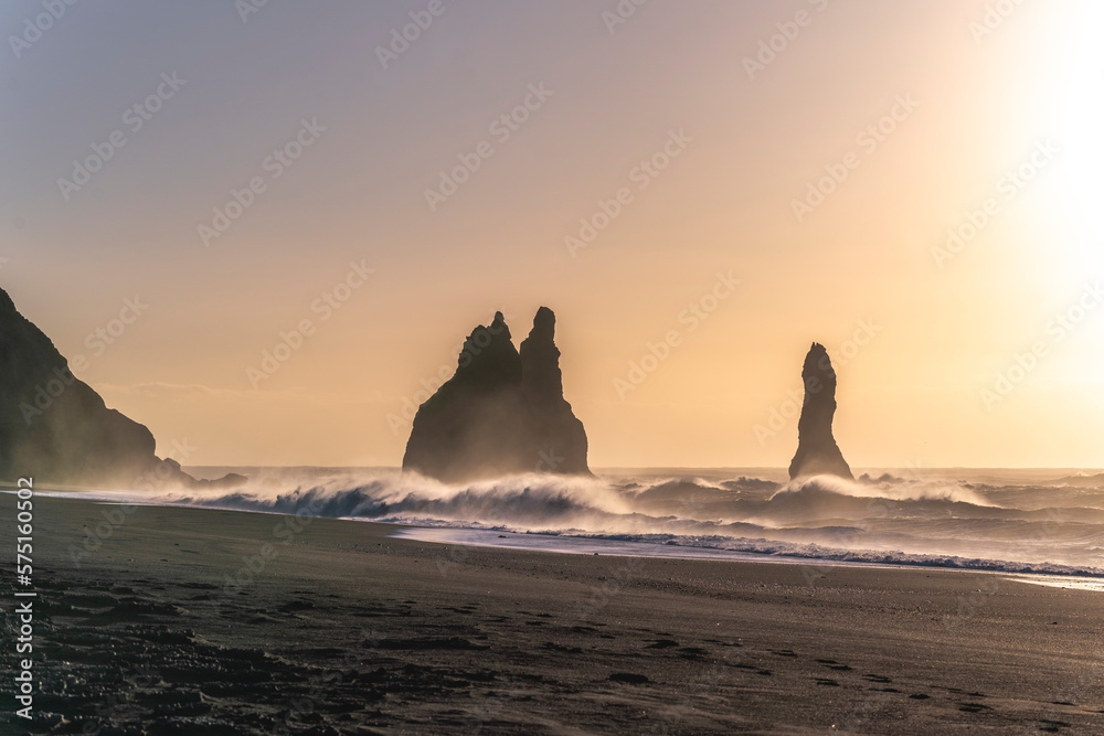 Black beach Iceland big waves during sunrise with birds hovering over the waves