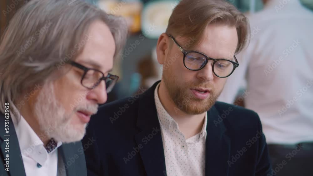 Close up of business partners have dinner and talk in restaurant. Realtime Close up of business partners have dinner and talk in restaurant. Realtime