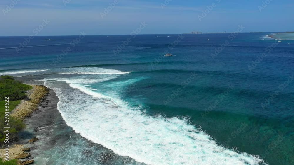 Aerial Idyllic View Of Wavy Seascape Under Sky, Drone Flying Forward During Sunny Day - Thulusdhoo, Maldives Aerial Idyllic View Of Wavy Seascape Under Sky, Drone Flying Forward During Sunny Day - Thulusdhoo, Maldives