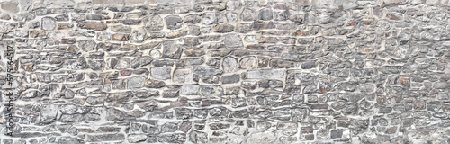 Rustic natural stone wall with wackerstones  in panoramic format.