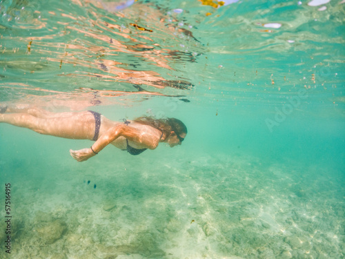 woman snorkeling in clear tropical sea