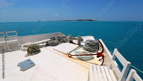 Slow Motion Shot Chairs By Rustic Anchor And Ropes On Boat Deck During Sunny Day - Thulusdhoo, Maldives photo