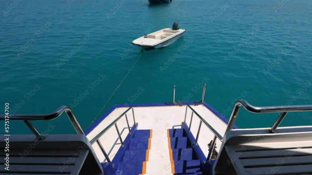 Slow Motion Tilt Up Shot Of Empty Safe Boat Attached To Passenger Ship On Sunny Day - Thulusdhoo, Maldives Slow Motion Tilt Up Shot Of Empty Safe Boat Attached To Passenger Ship On Sunny Day - Thulusdhoo, Maldives