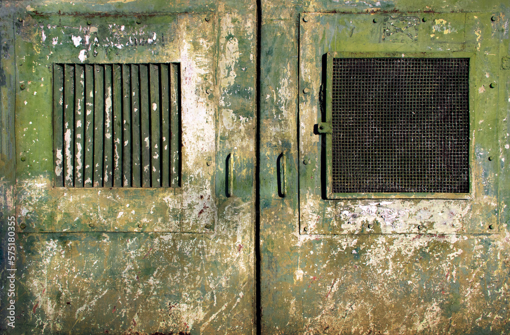 rusty weathered and dirty metal doors with windows of a military bunker or prison with chipped khaki green- textured surface for dystopian cyber punk army in a world war scenario wallpaper background rusty weathered and dirty metal doors with windows of a military bunker or prison with chipped khaki green- textured surface for dystopian cyber punk army in a world war scenario wallpaper background