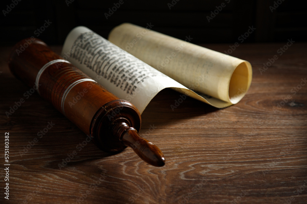 The Scroll of Esther on a dark wooden table. Rustic.