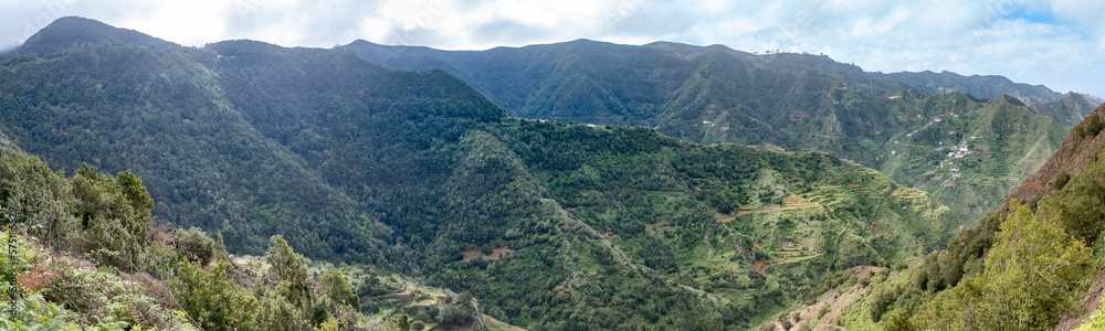 Amazing panorama landscape photo of green natural mountains and hills during winter summer travel in tenerife island, canarias, spain	