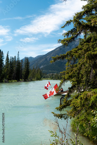 canadian flag on the edge of lake