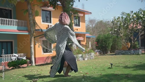 A young woman with purple hair is actively moving. Slow motion video