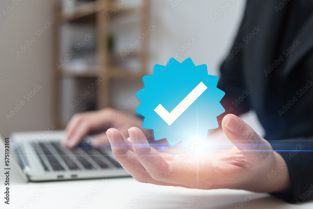 Businessman using laptop with verification account blue tick checkmark concept, verification account on social media platform, subscription status, eliminate bots, spam. Businessman using laptop with verification account blue tick checkmark concept, verification account on social media platform, subscription status, eliminate bots, spam.