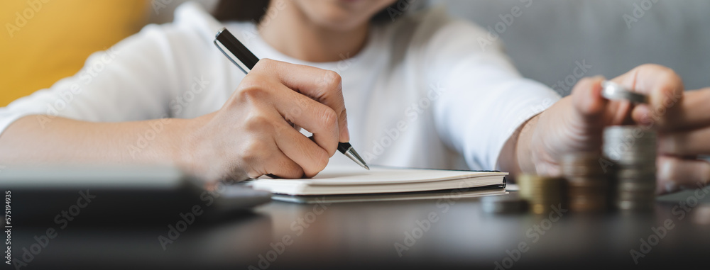 Close up hands of a Woman doing investment accounting for future wealth.