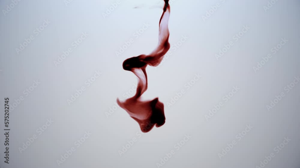 Red ink floating in water. Blood-like ink dropping into water and floating over white background making swirls. 3D render animation.