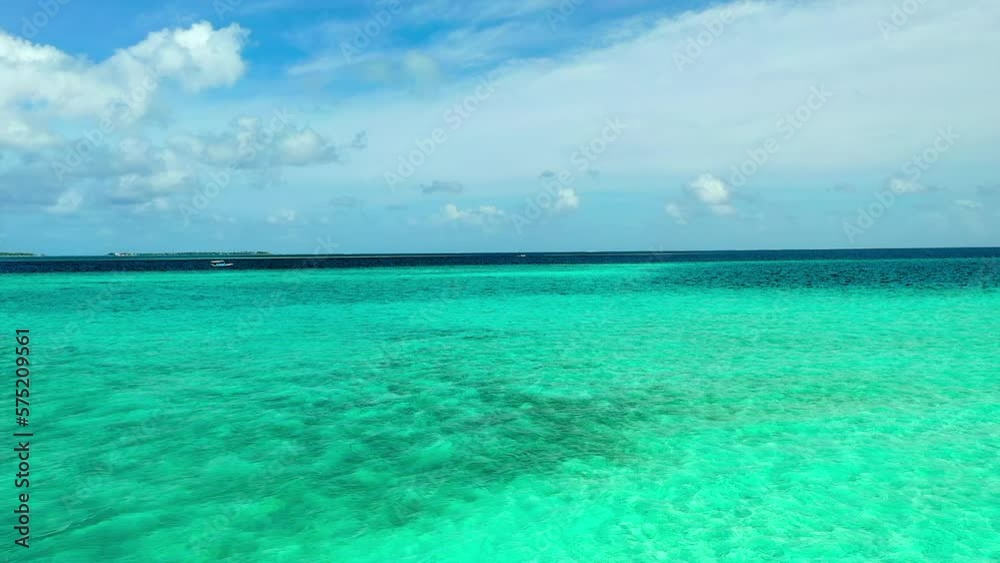 Aerial Shot Of Woman Sitting By Turquoise Sea Coastline, Drone Ascending Backwards Over Beach On Sunny Day - Thulusdhoo, Maldives Aerial Shot Of Woman Sitting By Turquoise Sea Coastline, Drone Ascending Backwards Over Beach On Sunny Day - Thulusdhoo, Maldives