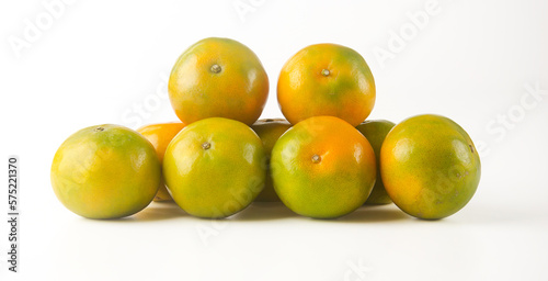 Heaps of tangerine oranges on a white background.