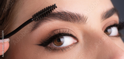 Canvas Print Close up eyebrows with eyebrow brush