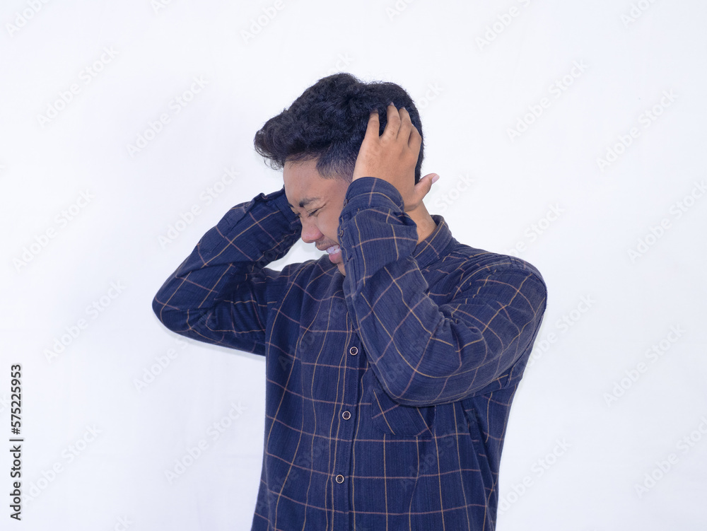Young asian man feeling stressed and frustrated holding head Young asian man feeling stressed and frustrated holding head