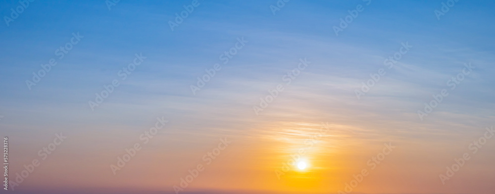 Obraz premium Sunset sky scene with a bright golden light. Beautiful sunrise with clouds soft. Nature background concept