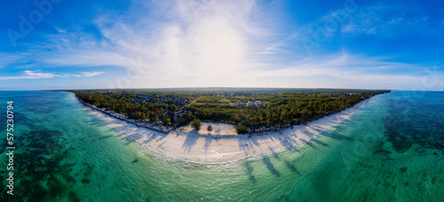 Indulge in a luxurious getaway at Zanzibar's Kiwengwa beach, where the white sand, turquoise waters, and palm trees create a serene and refreshing atmosphere for a truly memorable vacation.