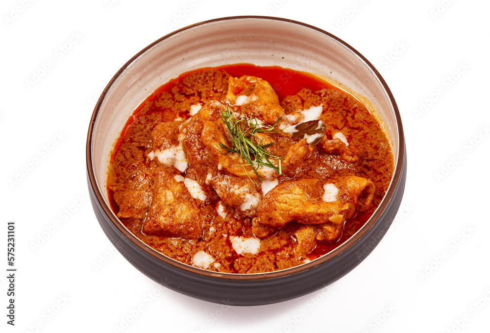 Panang pork curry with coconut milk and sliced kaffir lime leaves in a bowl isolated on white background, Panang curry is a very popular Thai dish. Panang pork curry with coconut milk and sliced kaffir lime leaves in a bowl isolated on white background, Panang curry is a very popular Thai dish.