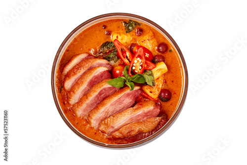 Top view of Red curry with roasted duck isolated on white background, this food contains such as red curry paste, chili, tomato and pineapple.